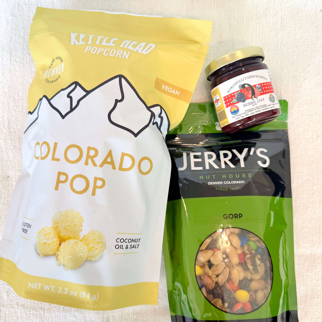 A little taste of Colorado, all wrapped up and ready to gift. Our Colorado Snack Pack Gift Set features a delicious lineup of locally loved favorites, including our best-selling Kettle Head popcorn, Jerry’s Nut House trail mix, and a jar of locally made Colorado jam.