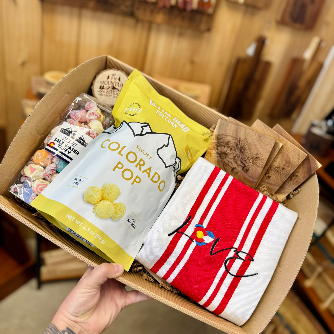 Gift Box containing Colorado themed items like snacks, towels, candies, ornament and coasters. Show your Centennial State Pride!