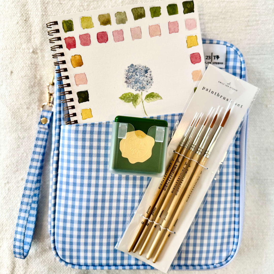 Our Create and Inspire Gift Set is designed for creatives, makers, and anyone who loves a little artistic escape. This thoughtfully curated set includes an Emily Lex water color paint color book, watercolor set, paint brushes, and a stylish clutch to keep all your art supplies organized in one place.