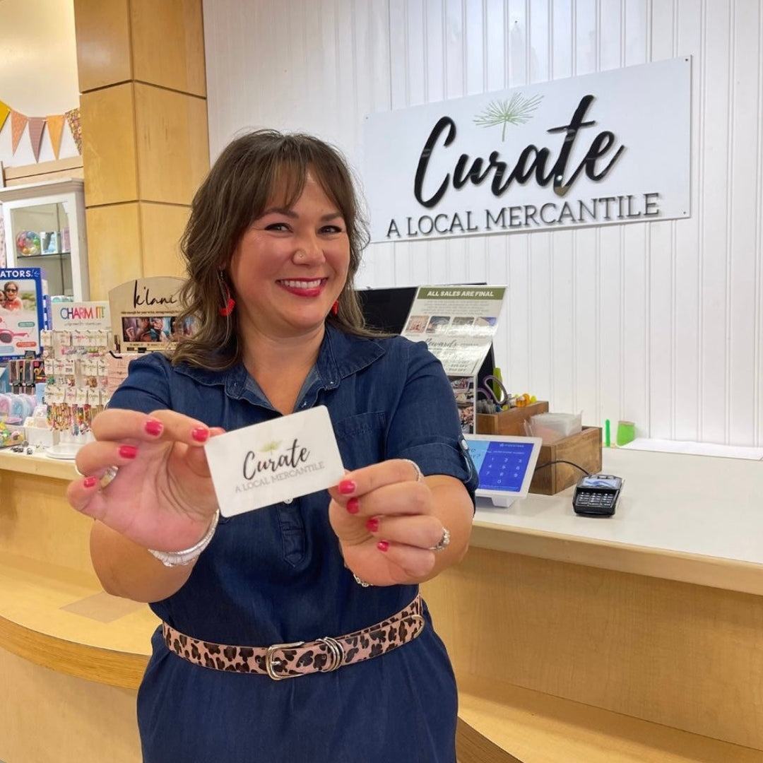 Owner Karli Millspaugh shows a Curate Mercantile Gift Card